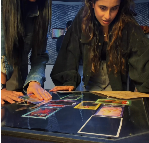 Seattle escape room interior. Two people examine tarot cards.